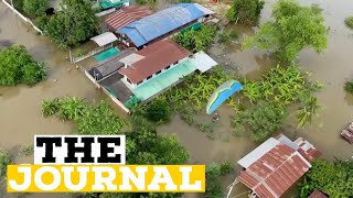 Thai paramotorists fly over flooded areas to drop off essential supplies