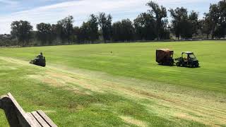 Dale and Desirae mowing polo field