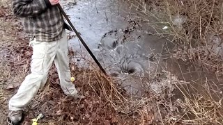 Unblocking a clogged drainage ditch on Christmas Day.