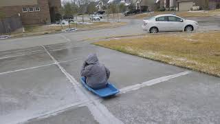 Sledding down driveway Wildwood at Oakcrest Cypress, Tx