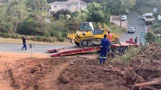 Offloading D65 Komatsu dozer from Low bed on busy road