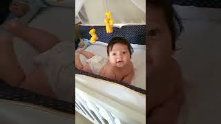 Cute Newborn Baby in Baby Cot.