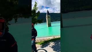 Riding around the old, submerged belltower of Graun/Curon in Italy.