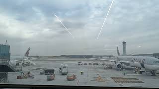 Unveiling the Wonders of Doha Hamad Airport: A Captivating Airplane View and Workers in Action