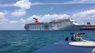 Ferry boat docking to a Carnival cruise ship.