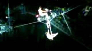 Motorcycle on tightrope with trapeze artist