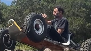 4 wheel drive go kart drives over logpile