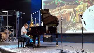 David playing on piano in musical school