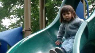 Sophie gets on the slide at the park and plays with the water!